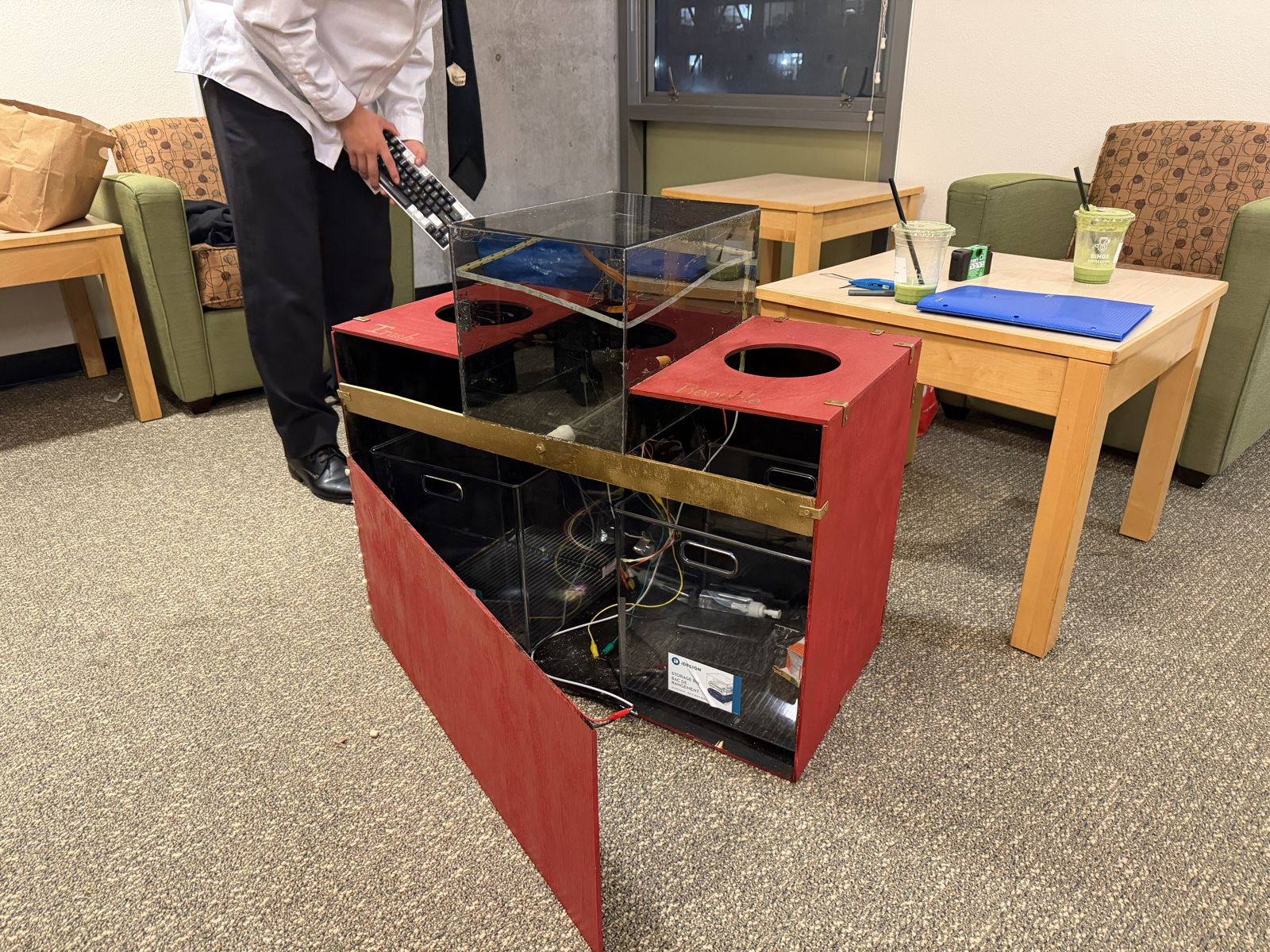 The finished smart waste sorter: a wood and polycarbonate enclosure with two openings